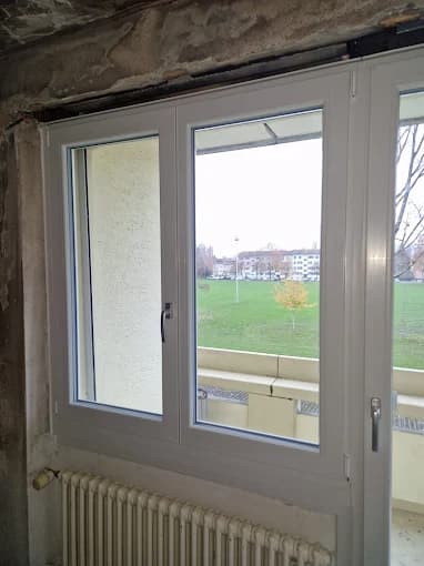 White two-sash window above a radiator during renovation work
