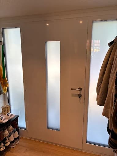 Interior view of a white door with frosted glazing on both sides