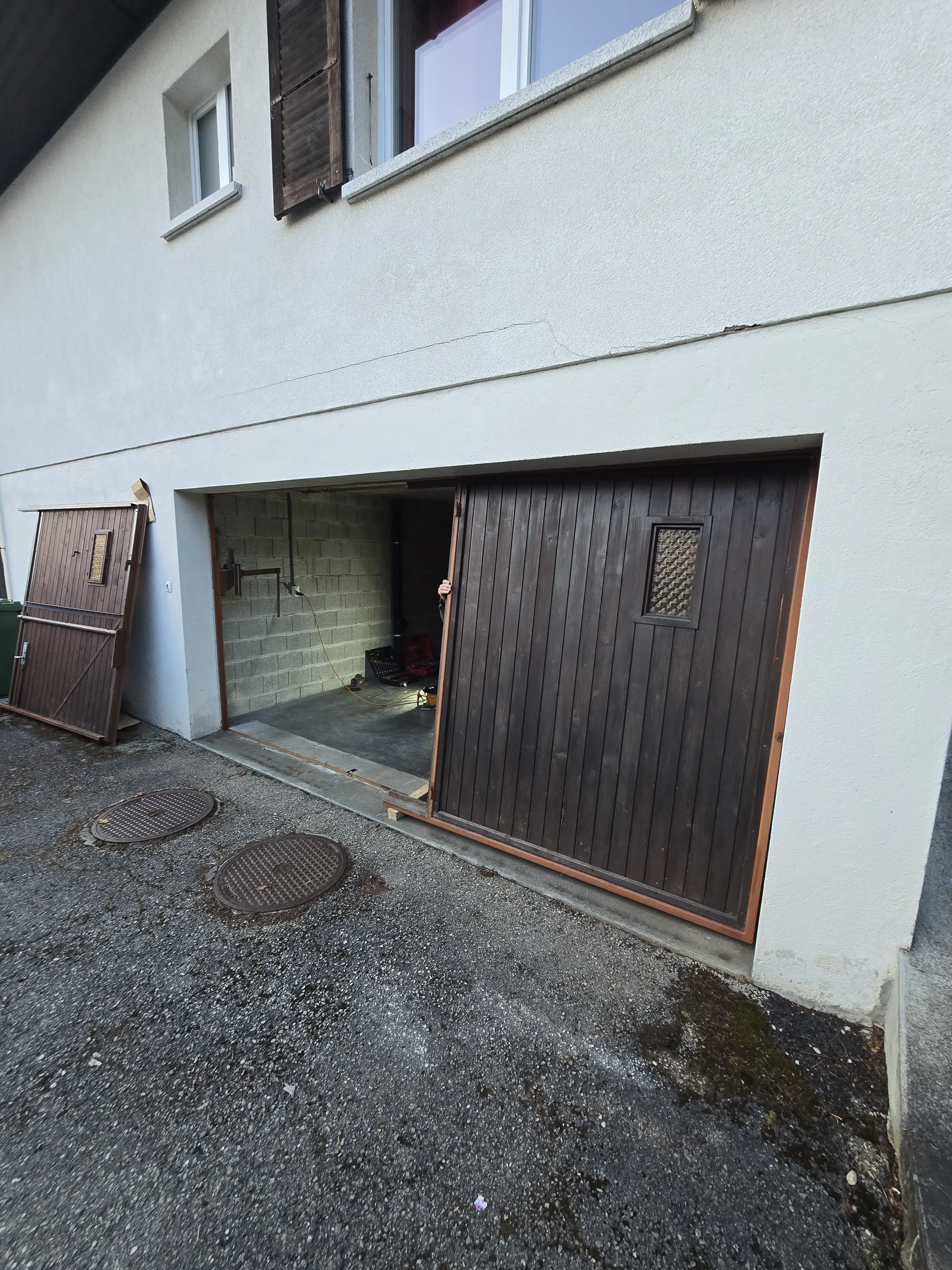Wooden panels being removed from an old garage door